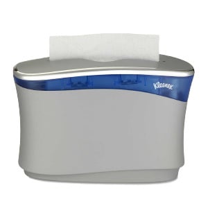 A white and blue Kleenex® Reveal™ Countertop tissue dispenser on a white background.