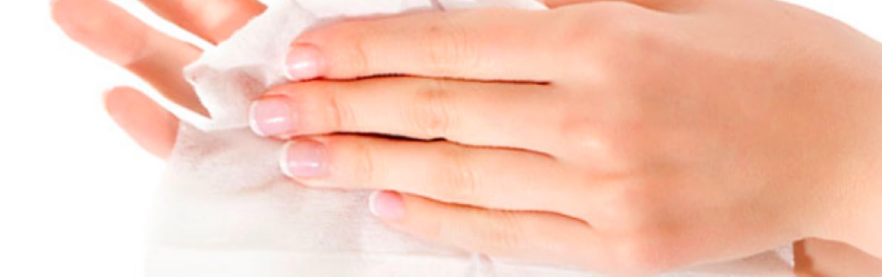 Close of up womans hands using a disposable wipe