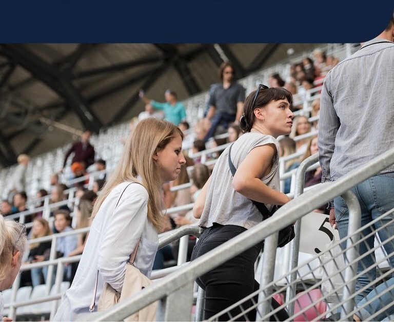 People in a crowded stadium highlighting hygiene concerns in high-traffic environments 